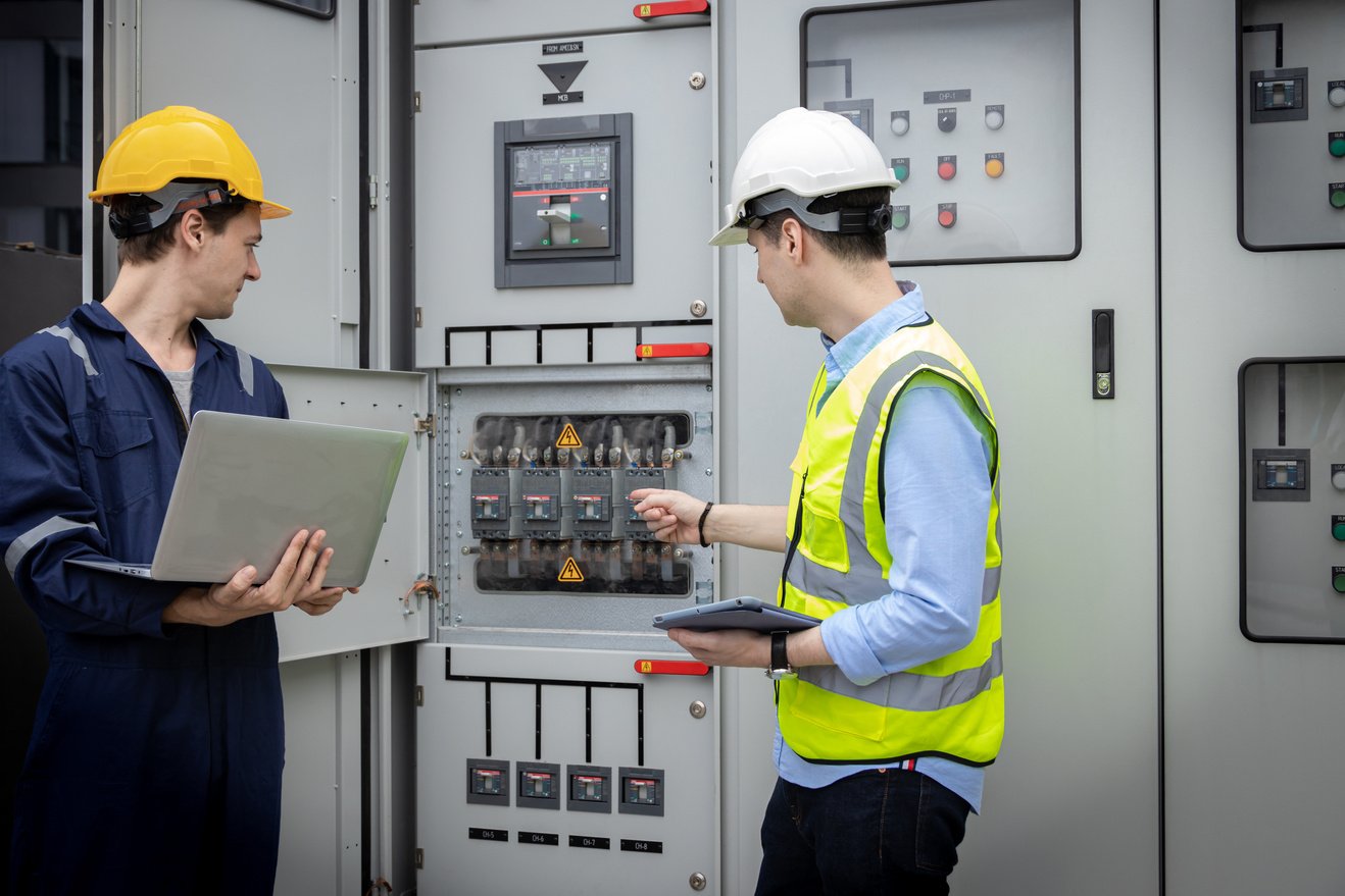 Electrical engineer working in control room. Electrical engineer